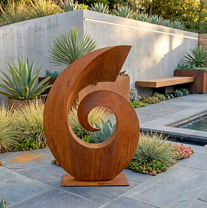 a large, abstract sculpture made of rusted metal, situated in a garden setting with various plants and a pool in the background.