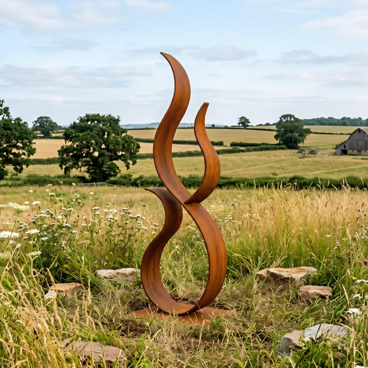 a large, abstract sculpture made of curved metal pieces, situated in a grassy field with trees and a barn in the background.