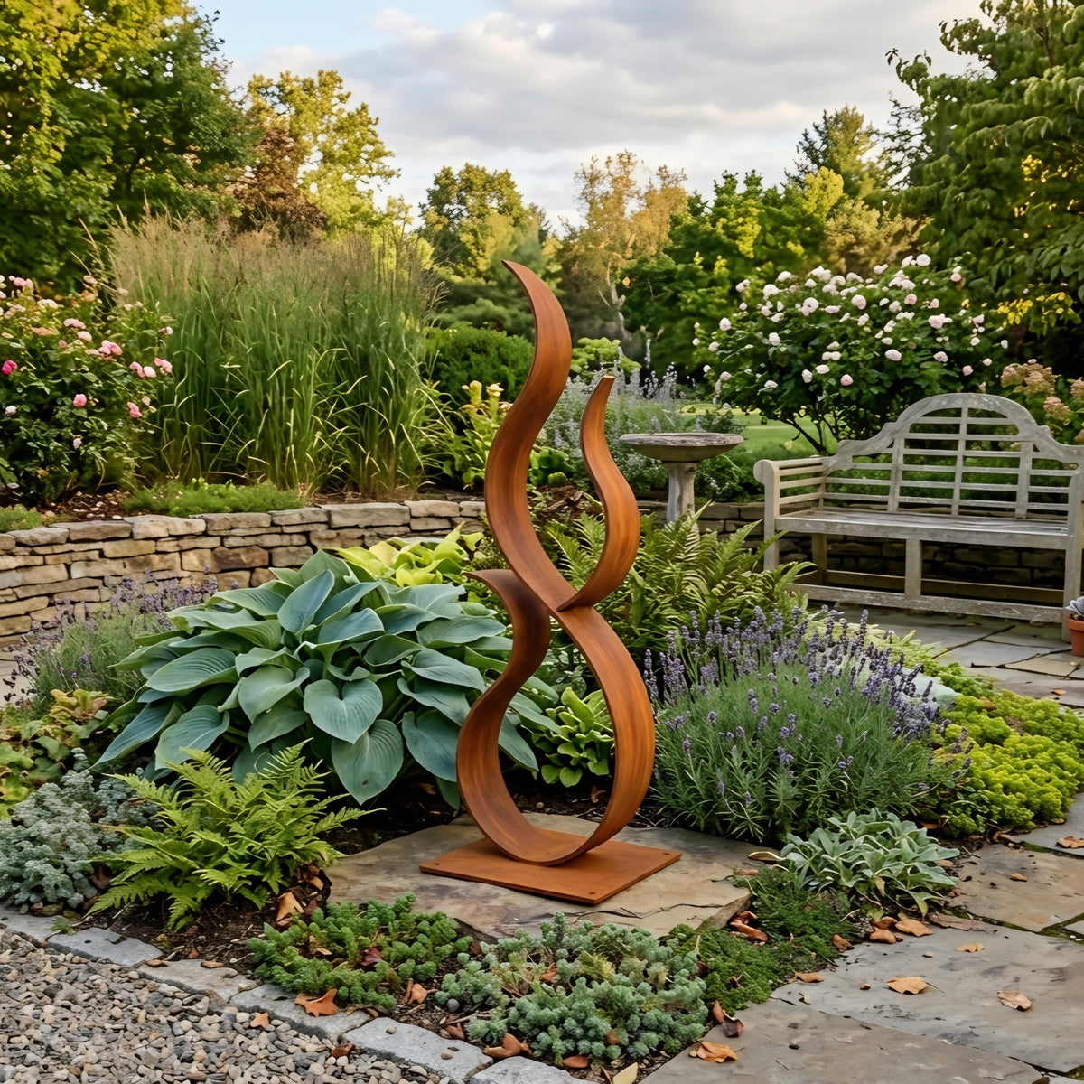 A garden with a large, abstract metal sculpture resembling a flame or a snake-like shape, surrounded by various plants and flowers.
