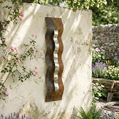 a rustic garden scene with a decorative metal sculpture on a stone wall, surrounded by lush greenery and colorful flowers.