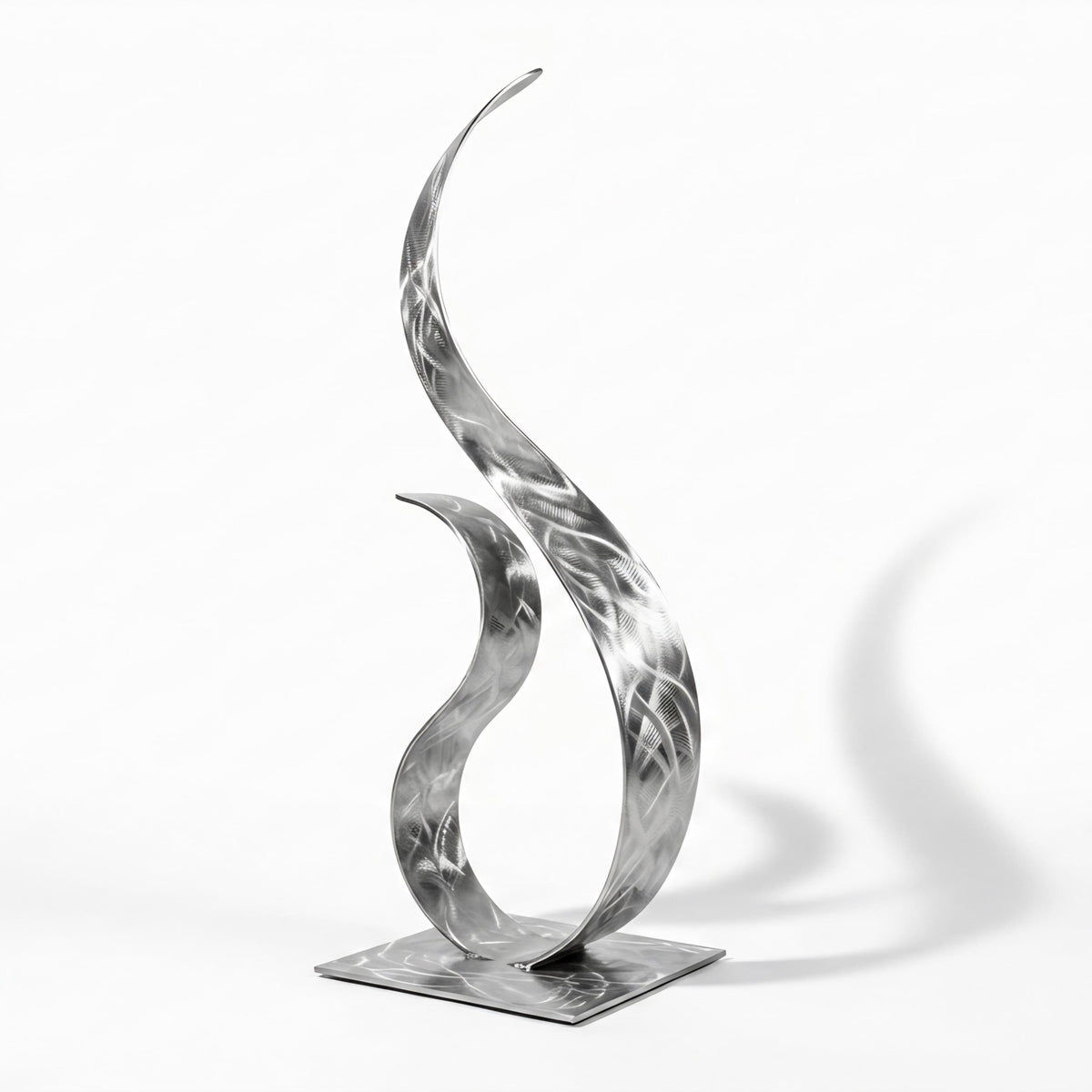 A modern, abstract metal sculpture with a unique, organic shape resembling a flame or a plant-like form.