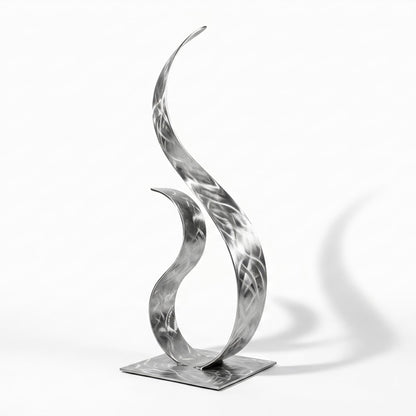 A modern, abstract metal sculpture with a unique, organic shape resembling a flame or a plant-like form.