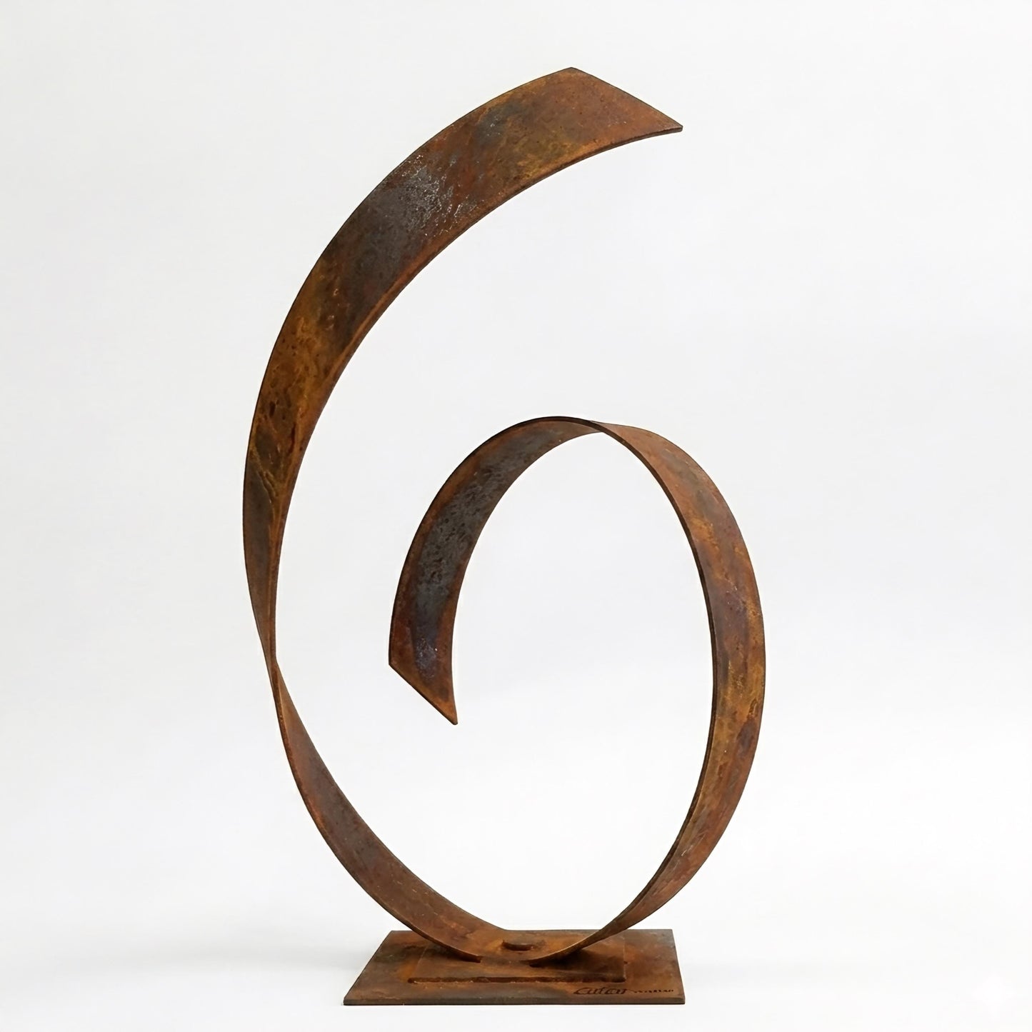 a large, rusted metal sculpture with a unique, abstract design.