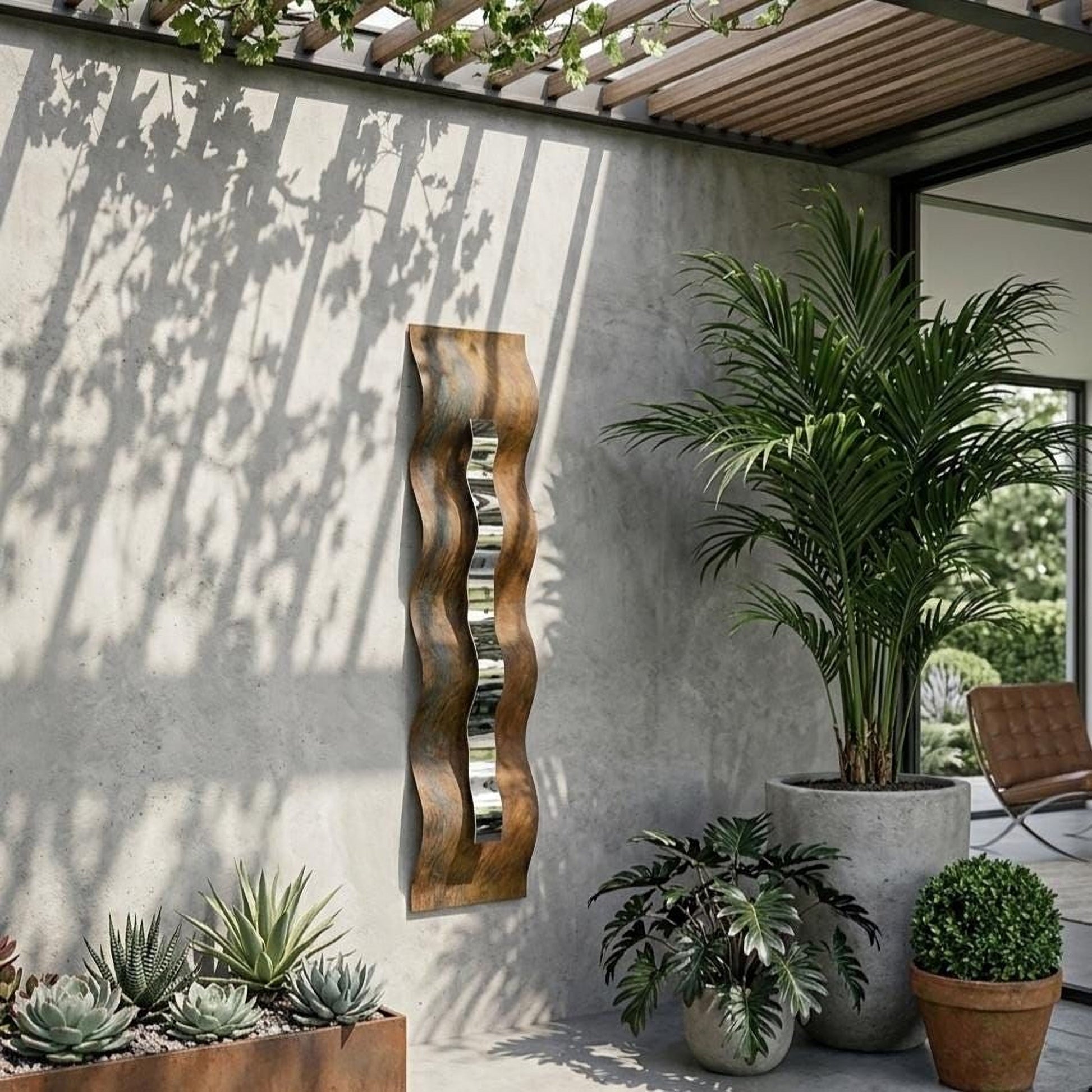 a modern outdoor patio with a concrete wall, a wooden sculpture, and various potted plants.