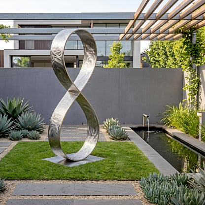 a modern garden with a large metal sculpture resembling an infinity symbol, surrounded by lush greenery and a small pond.