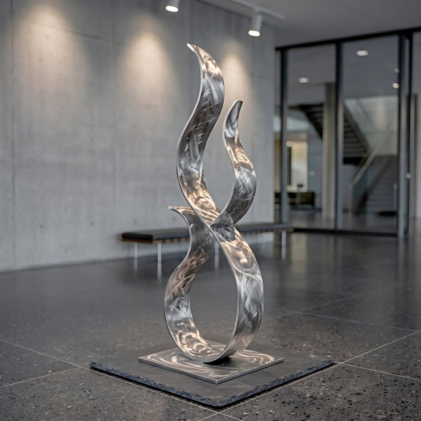 a modern, abstract sculpture composed of curved, metallic elements that create a dynamic and visually striking piece of art.