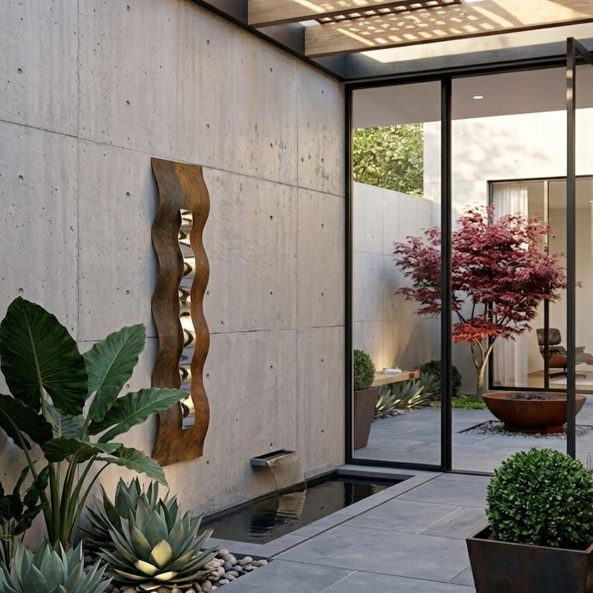 a modern outdoor space with a concrete wall, a glass door, and various plants and decorative elements.