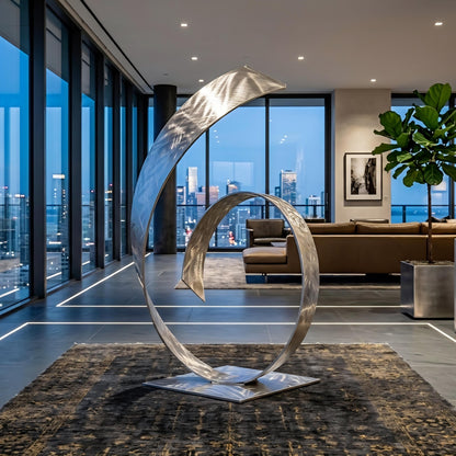 a modern living room with a large, abstract metal sculpture in the center. The room has large windows that provide a view of the city skyline, and the furniture includes a sofa and a potted plant.