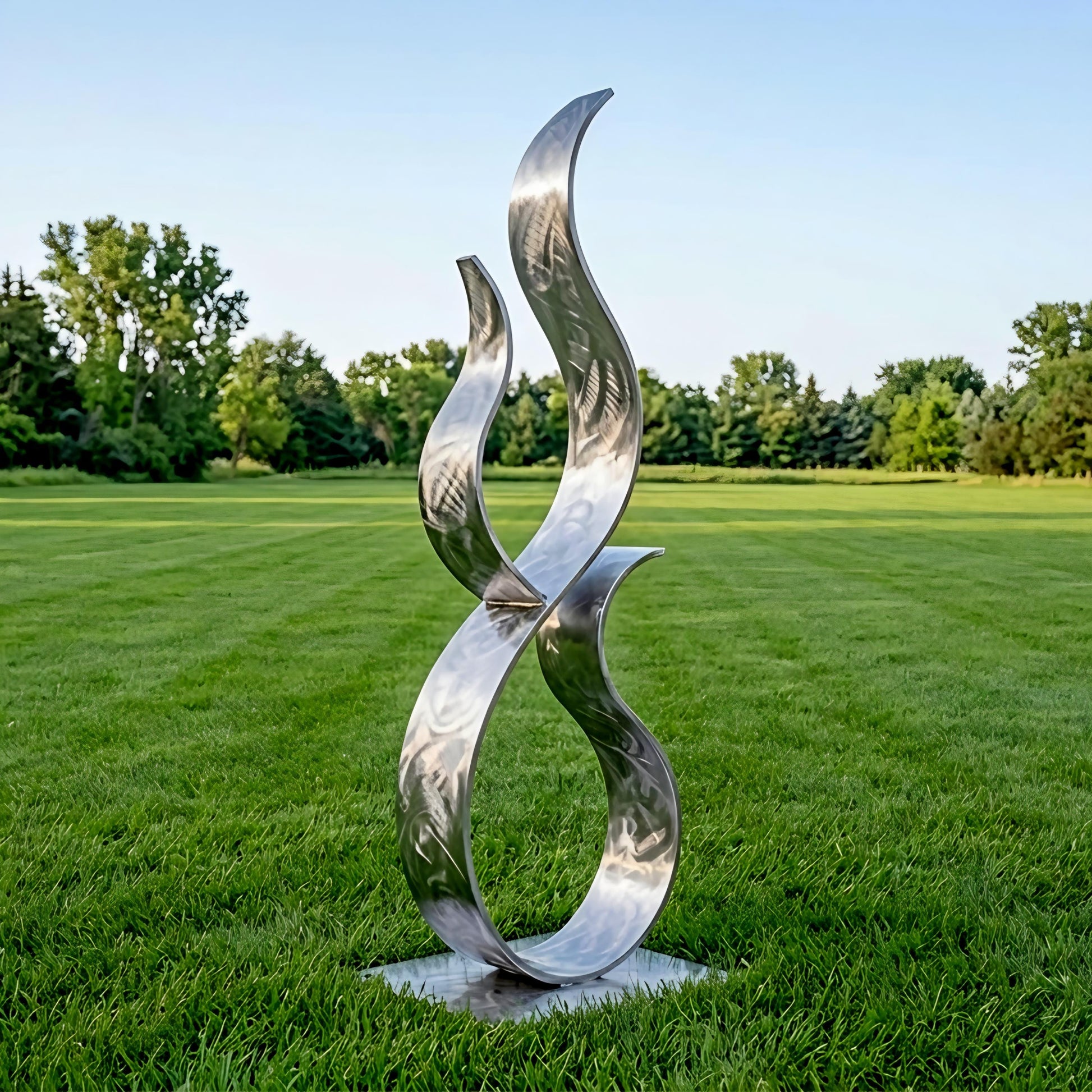 A large, abstract metal sculpture resembling a flame or fire stands in a grassy field, with trees visible in the background.
