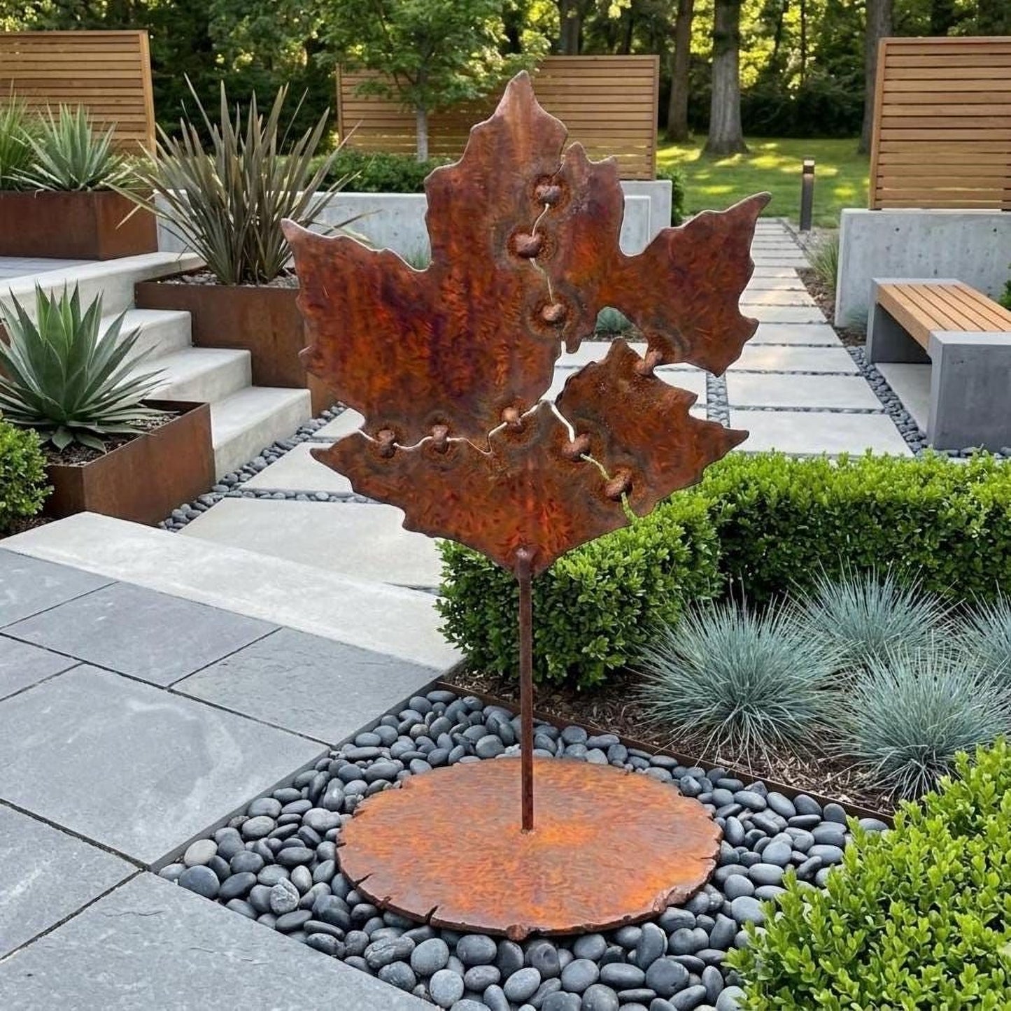 a large, rust-colored metal sculpture of a leaf, which appears to be a garden decoration. The sculpture is situated in a garden setting with various plants and rocks surrounding it.