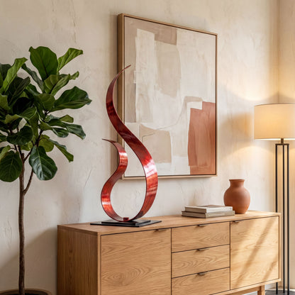 a modern interior design with a wooden dresser, a large abstract sculpture, a potted plant, and a framed artwork on the wall.