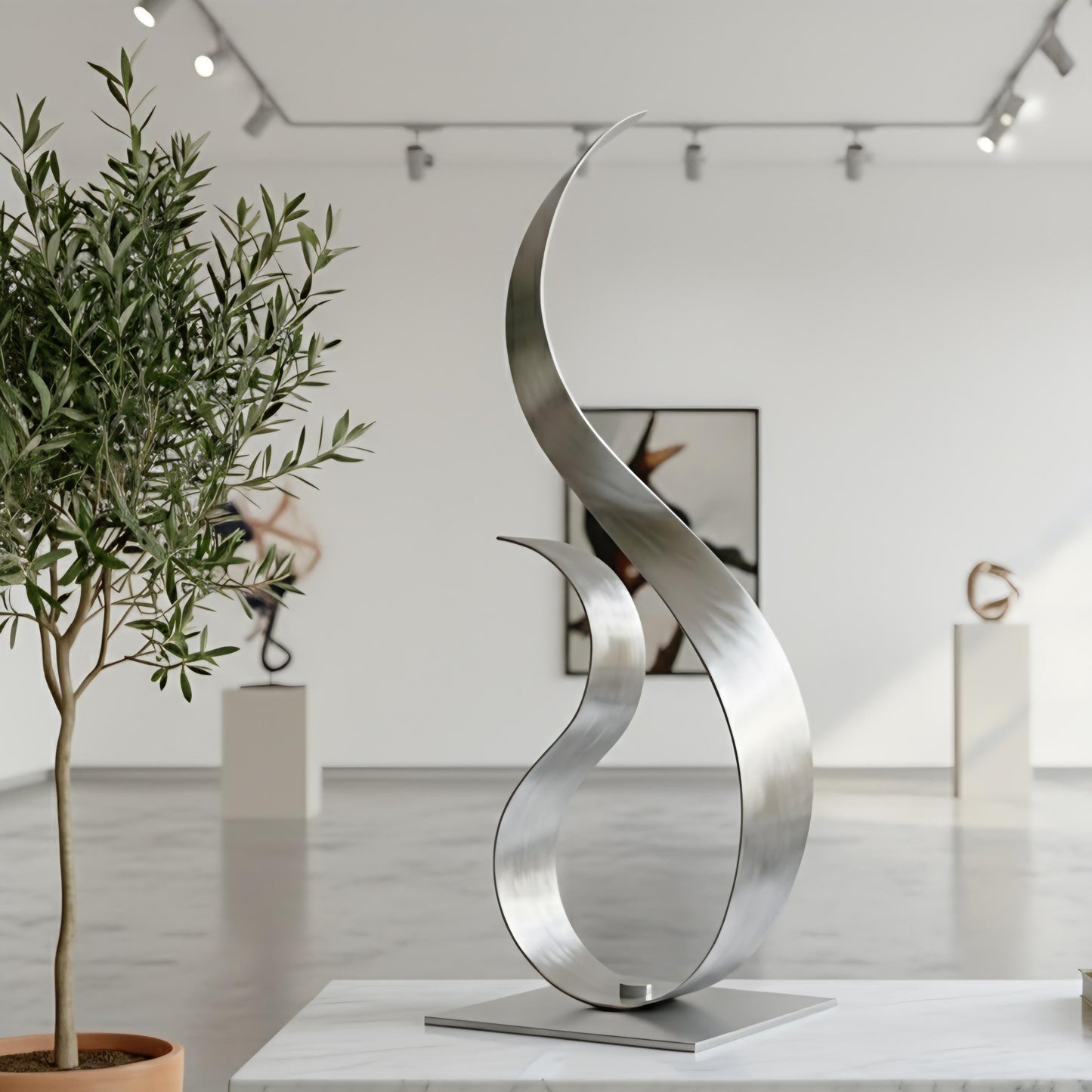 a modern art gallery with a large, abstract sculpture in the foreground, and other sculptures displayed in the background.
