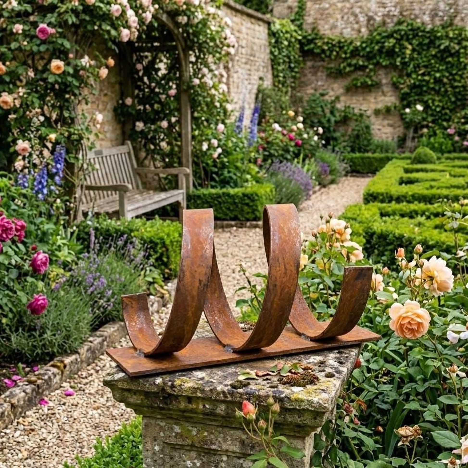 A rustic metal sculpture in a lush garden, surrounded by vibrant flowers and greenery.