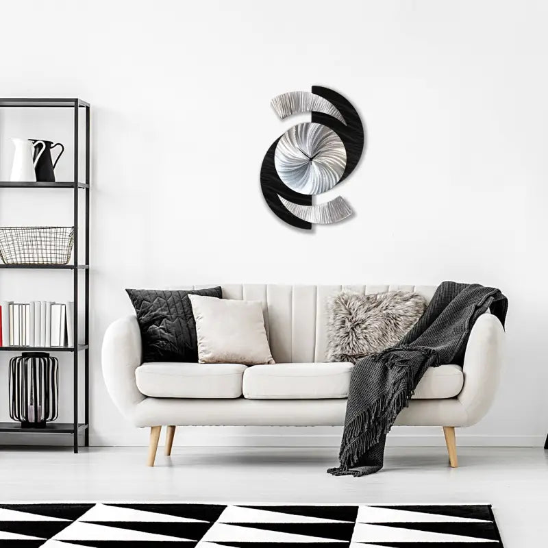 a living room with a white couch and black and white rug