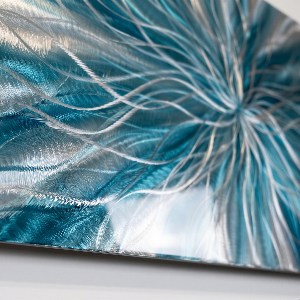 a close up of a metal plate with blue feathers on it