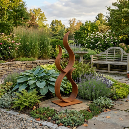 A rust-colored metal sculpture resembling a flame stands in a lush garden, surrounded by various plants and flowers.