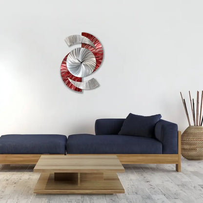 a large metal wall clock with a red and white design