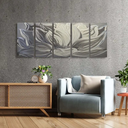 a modern living room with a grey couch and a large white flower